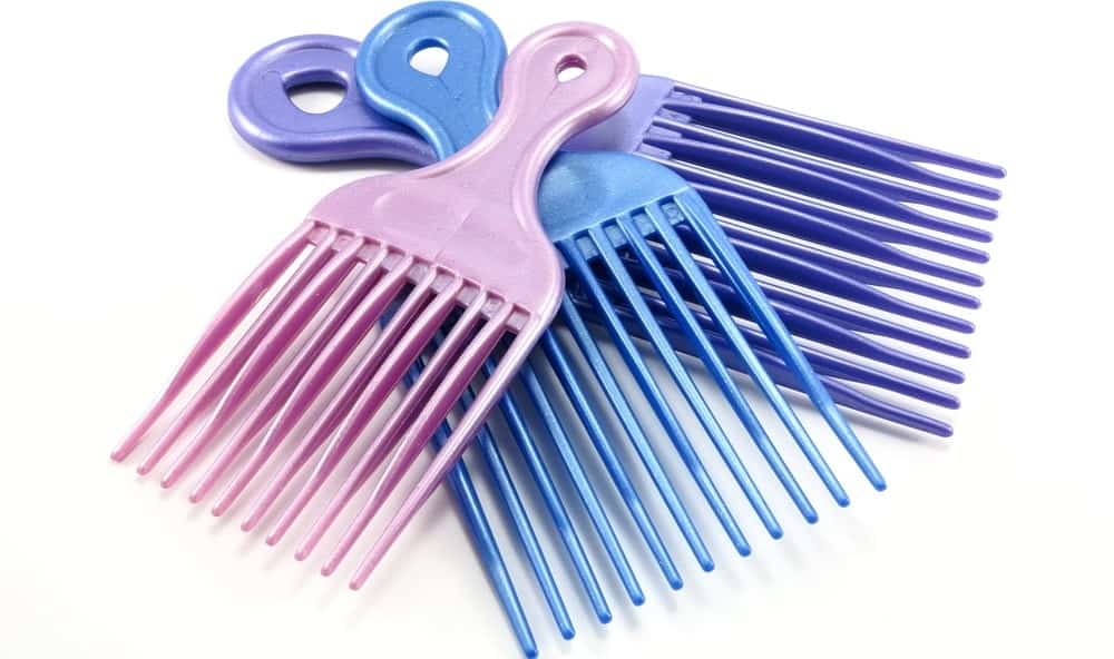 A set of three colorful plastic pick combs.