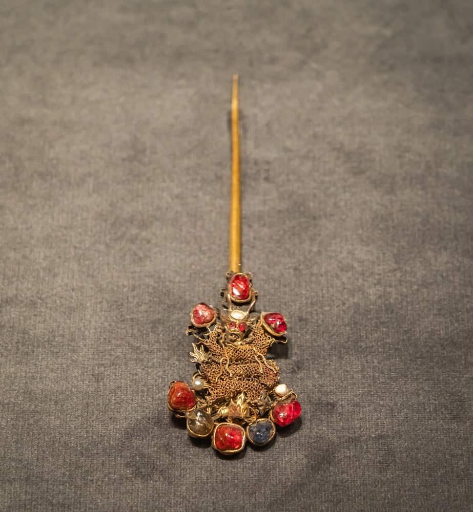 An ancient Chinese hair pin with a figure of an eastern dragon.