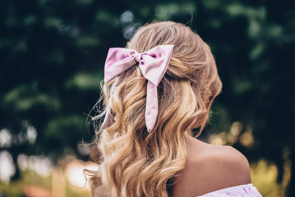 A woman wearing a ribbon bow on her hair.