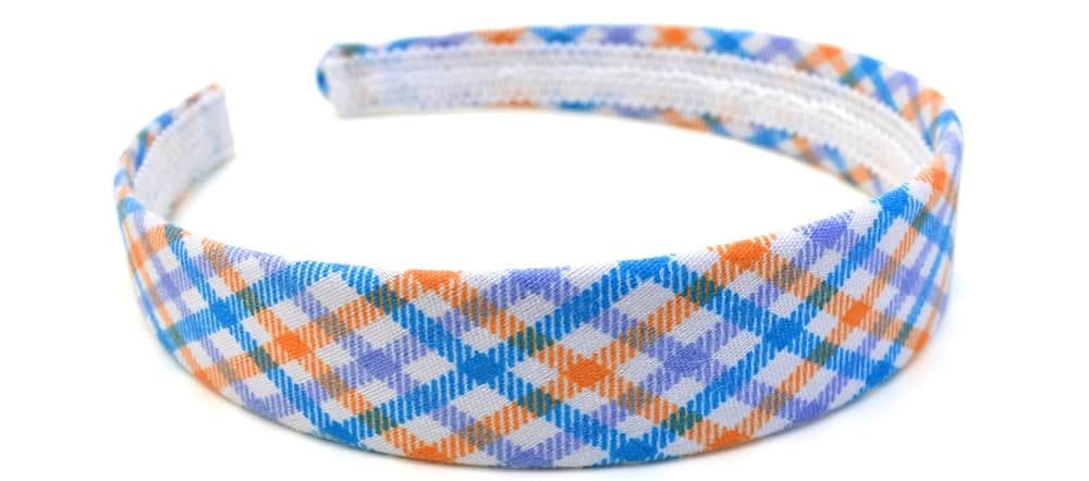 A close look at a checkered colorful horseshoe headband.