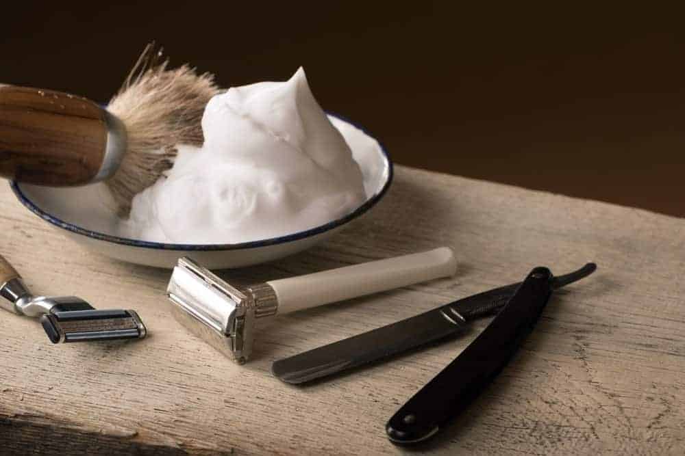 Shaving blades along with combo, brush and shaving foam in a ceramic plate.