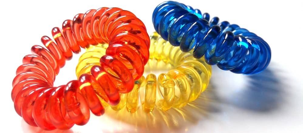 Three colorful spiral hair ties.