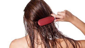 A woman brushing her long wet hair.