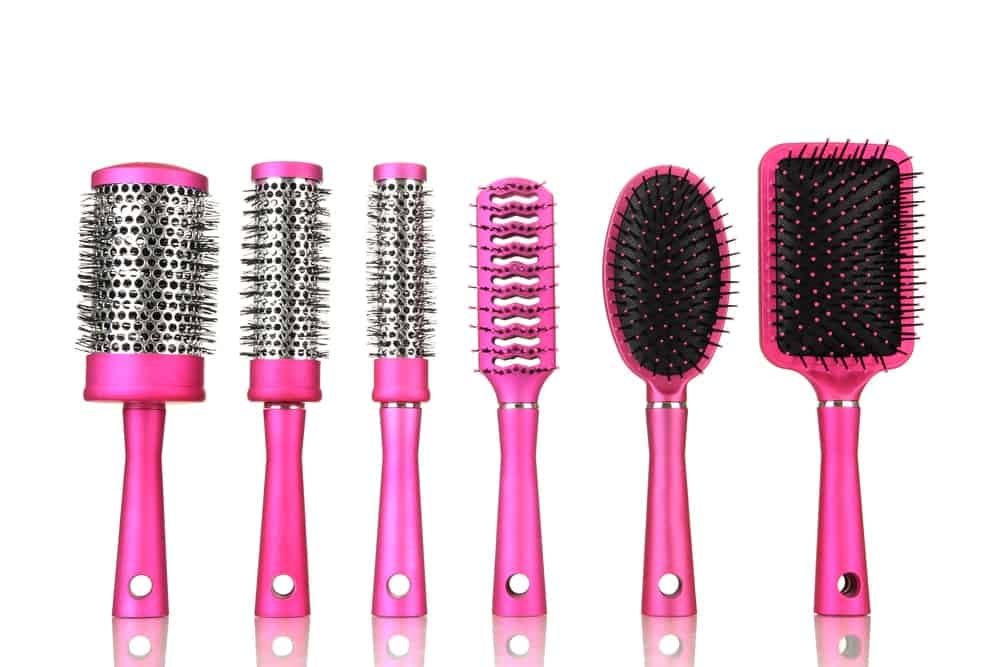 A row of various hair brushes.