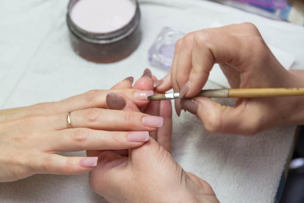 A close look at a woman having her nails done at the salon.